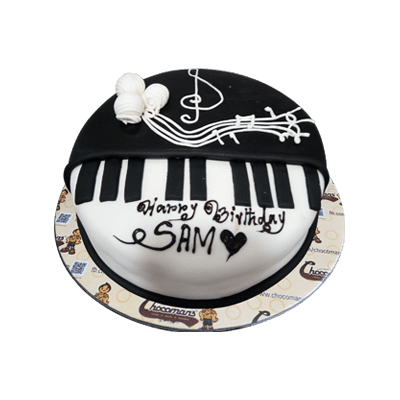 Music and piano theme kids birthday party. Kid with black and white cake.  Child blowing candles and opening present. Little boy celebrating birthday  Stock Photo - Alamy